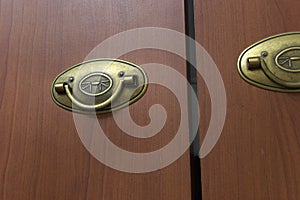 wardrobe doors with foldable pull handle. artificially aged brass