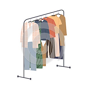 Wardrobe of modern women clothing hanging on floor hanger rack. Assortment of casual apparels. Collection of stylish