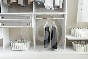 Wardrobe with shirts and pants hanging