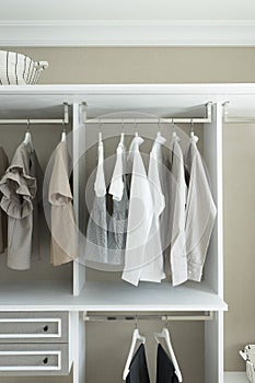 Wardrobe with shirts and pants hanging