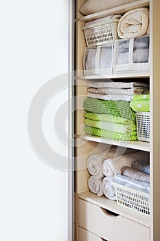 Wardrobe with women`s and men`s clothing. Drawers with underwear, bed linen, socks and shirts