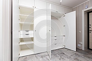 wardrobes with hinged doors on white door hinges, in the apartment