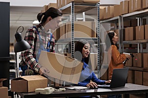 Warehouse asian employees managing ecommerce order fulfillment in storage