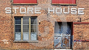 Warehouse brick front background with Store House stenciled above door