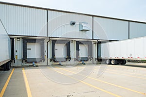 Warehouse building with 53 foot dry van trailers backed into doc