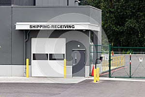 Warehouse building shipping receiving garage door and gate with road driveway