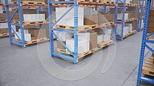 Warehouse with cardboard boxes inside on pallets racks, logistic center. Huge, large modern warehouse. Warehouse filled