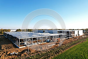 Warehouse Construction from metal structure. Industrial building on light gauge steel framing. Frame of modern hangar or factory.