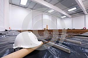 Warehouse construction site. White engineer helmet on floor