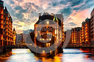 The Warehouse district Speicherstadt during twilight sunset in Hamburg, Germany. Illuminated warehouses in Hafencity quarter in