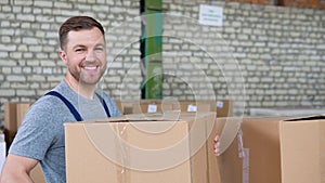 Warehouse employee collects an order, taking cardboard boxes and parcels from the shelf