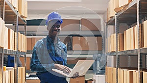 Warehouse employee counting goods boxes on racks