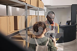 Warehouse employee searching parcel using checklist