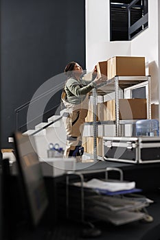 Warehouse employee taking out cardboard box