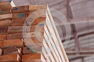 Warehouse or factory for sawing boards on sawmill indoors. Wood timber stack of wooden blanks construction material