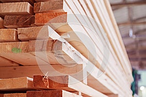 Warehouse or factory for sawing boards on sawmill indoors. Wood timber stack of wooden blanks construction material