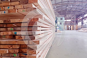 Warehouse or factory for sawing boards on sawmill indoors. Wood timber stack of wooden blanks construction material photo