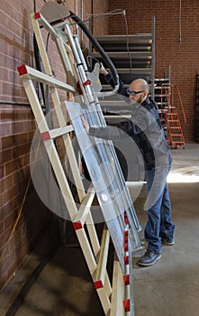 Warehouse factory worker using a vertical saw