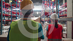 Warehouse factory workers wearing uniforms carrying parcel boxes them on product shelf, Male and female workers working in storeho