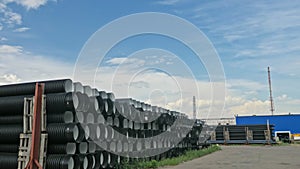 Warehouse of finished plastic pipes industrial outdoors storage site. Manufacture of plastic water pipes factory.