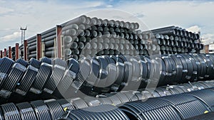 Warehouse of finished plastic pipes industrial outdoors storage site. Manufacture of plastic water pipes factory.