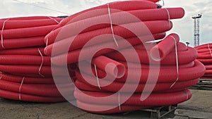 Warehouse of finished plastic pipes industrial outdoors storage site. Manufacture of plastic water pipes factory.