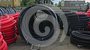 Warehouse of finished plastic pipes industrial outdoors storage site. Manufacture of plastic water pipes factory.