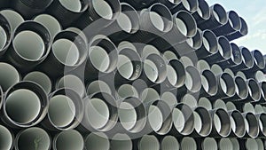 Warehouse of finished plastic pipes industrial outdoors storage site. Manufacture of plastic water pipes factory.