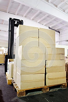 Warehouse forklift stacker with boxes photo