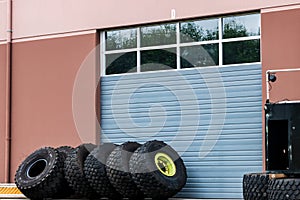 Warehouse industrial building windowed garage door with tires
