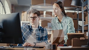 Warehouse Inventory Manager and Worker Using Desktop Computer, Preparing a Parcel for Shipping