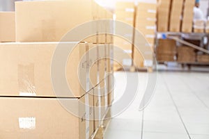 Warehouse with its own production. A pile of cardboard boxes on a pallet. The concept of shipping and delivery of goods from a