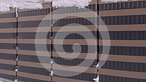 Warehouse of liter brown bottles on the street under the snow in winter.