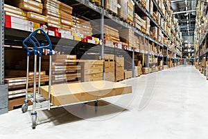 Warehouse logistics - box on trolley in modern distribution center