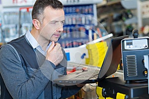 warehouse man using laptop in warehouse