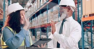 Warehouse, man and woman with a tablet, high five and conversation with planning and cooperation. Safety, manufacturing