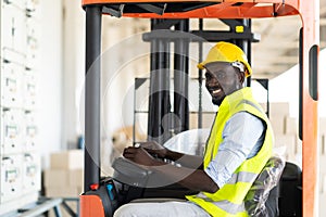 Warehouse man worker driver forklift. warehouse worker driver stacking card boxes by forklift in warehouse store. African American