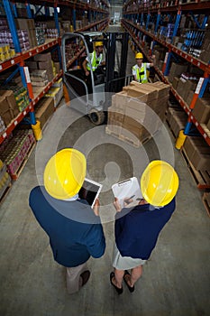 Warehouse manager and client standing