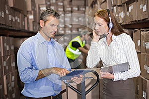 Warehouse manager and foreman working together