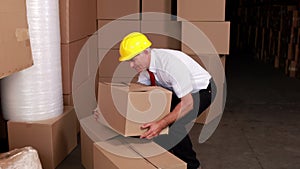 Warehouse manager injuring his back moving boxes