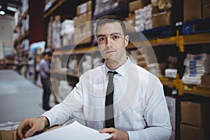 Warehouse manager looking at camera