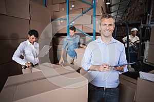 Warehouse manager using his tablet pc