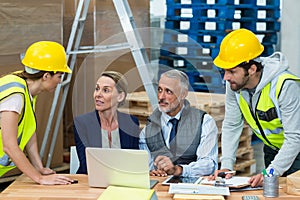 Warehouse managers interacting with workers