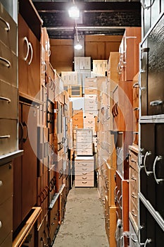 Warehouse of office furniture. Unusual corridor of bedside tables. Furniture store.
