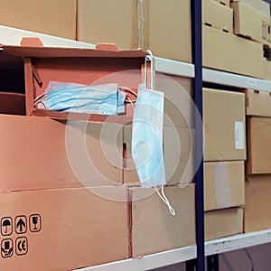 Warehouse with opened boxes of medical masks. Theft of face masks at a postal warehouse during quarantine due to coronavirus