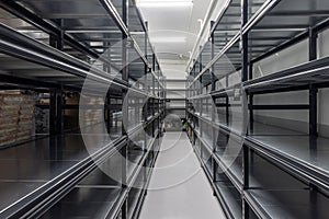 Warehouse racks storage metal pallet racking system in warehouse. Modern interior of new empty warehouse. The shelves are pallet