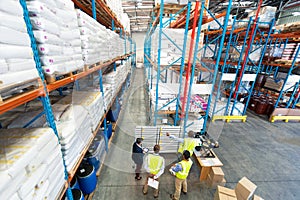 Warehouse staff discussing over whiteboard in warehouse