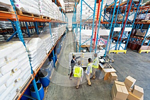 Warehouse staff discussing over whiteboard in warehouse