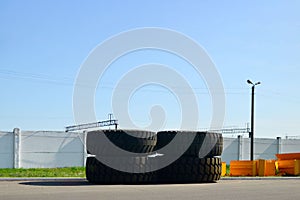 Warehouse with tires for trucks at an industrial plant for the production of cars. The protector of a large rubber wheel.