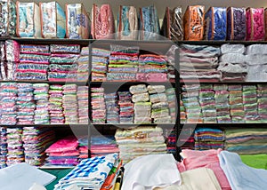 Warehouse of towel softness fluffy fiber fabric on shelf